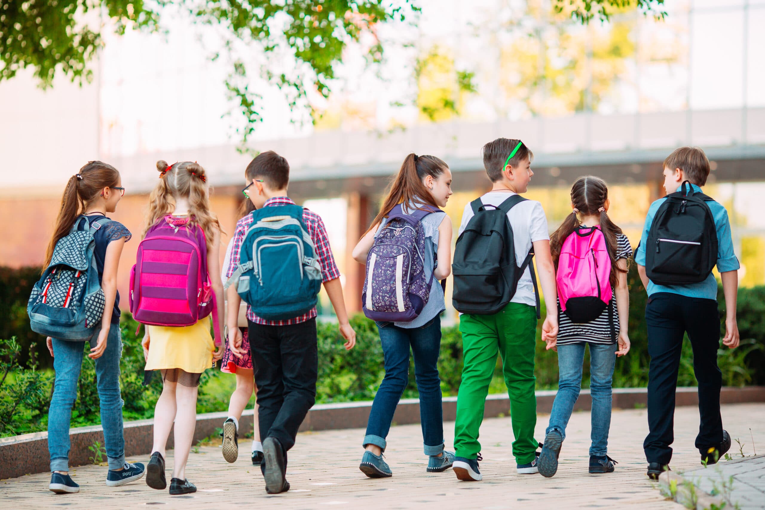 elementary school kids wearing backpacks